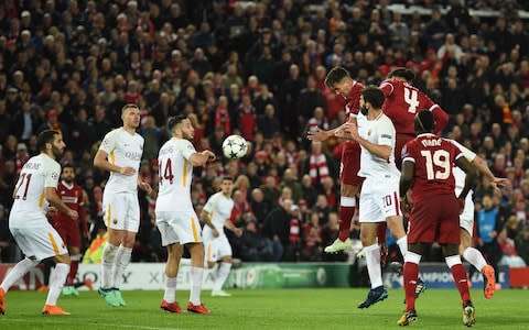 Firmino beats Fazio to score Liverpool's fifth - Credit: OLI SCARFF/AFP/Getty Images