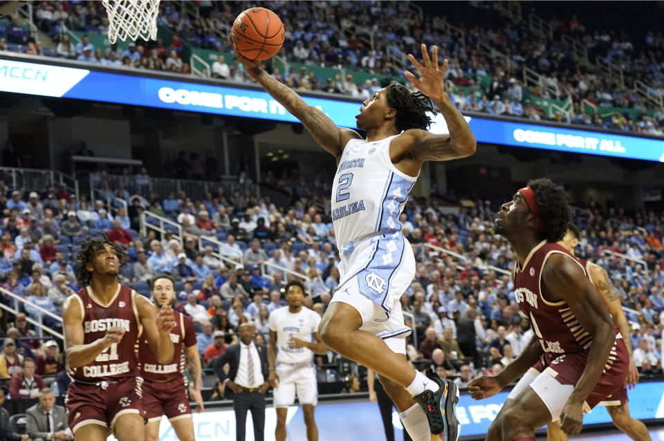 North Carolina guard Caleb Love (2) drives past Boston College guard Prince Aligbe (10) during the first half of an NCAA college basketball game at the Atlantic Coast Conference Tournament in Greensboro, N.C., Wednesday, March 8, 2023. (AP Photo/Chuck Burton)