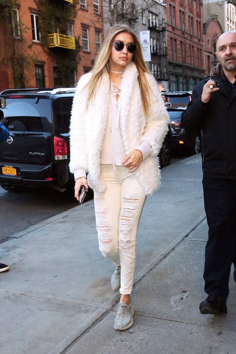 Gigi wearing<b><a rel="nofollow noopener" href="http://www.polyvore.com/cgi/shop?query=j+brand+white+distressed" target="_blank" data-ylk="slk:J Brand;elm:context_link;itc:0;sec:content-canvas" class="link ">J Brand</a></b> Jeans <br><br>Credit: Splash