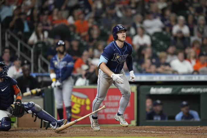 Tampa Bay Rays' Taylor Walls, right, watches his home run against the Houston Astros during the eighth inning of a baseball game Friday, Sept. 30, 2022, in Houston. (AP Photo/David J. Phillip)