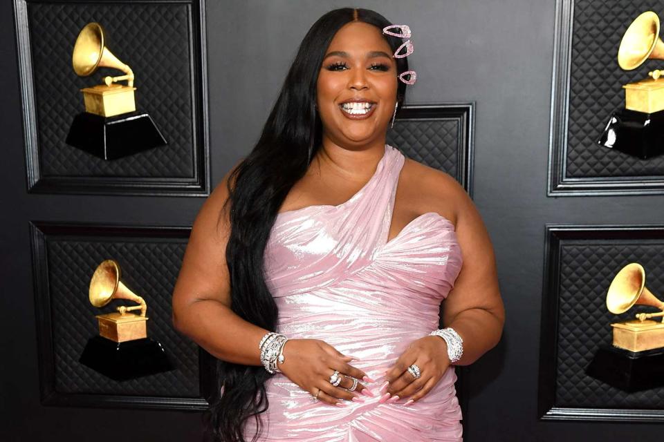 <p>Kevin Mazur/Getty</p> Lizzo — here at the Grammy Awards in 2021 — talked about being 