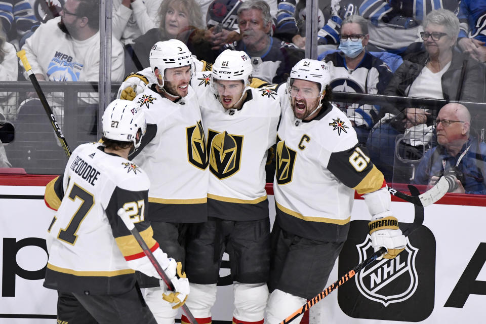 Vegas Golden Knights' Brett Howden (21) celebrates his goal against the Winnipeg Jets with Brayden McNabb (3) and Mark Stone (61) during first-period Game 4 NHL Stanley Cup first-round hockey playoff action in Winnipeg, Manitoba, Monday April 24, 2023. (Fred Greenslade/The Canadian Press via AP)