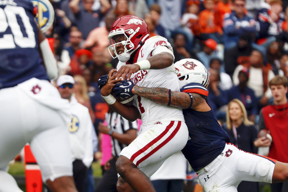 Arkansas quarterback KJ Jefferson scrambles for a touchdown as Auburn safety Donovan Kaufman, right, tries to tackle him during the first half of an NCAA college football game, Saturday, Oct. 29, 2022, in Auburn, Ala. (AP Photo/Butch Dill)