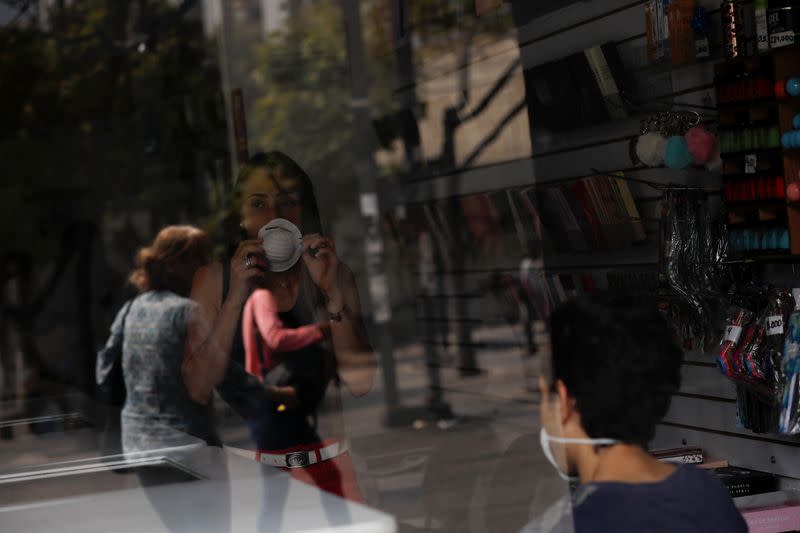 A woman wears a protective mask inside a shop in response to coronavirus (COVID-19) spread, in Caracas