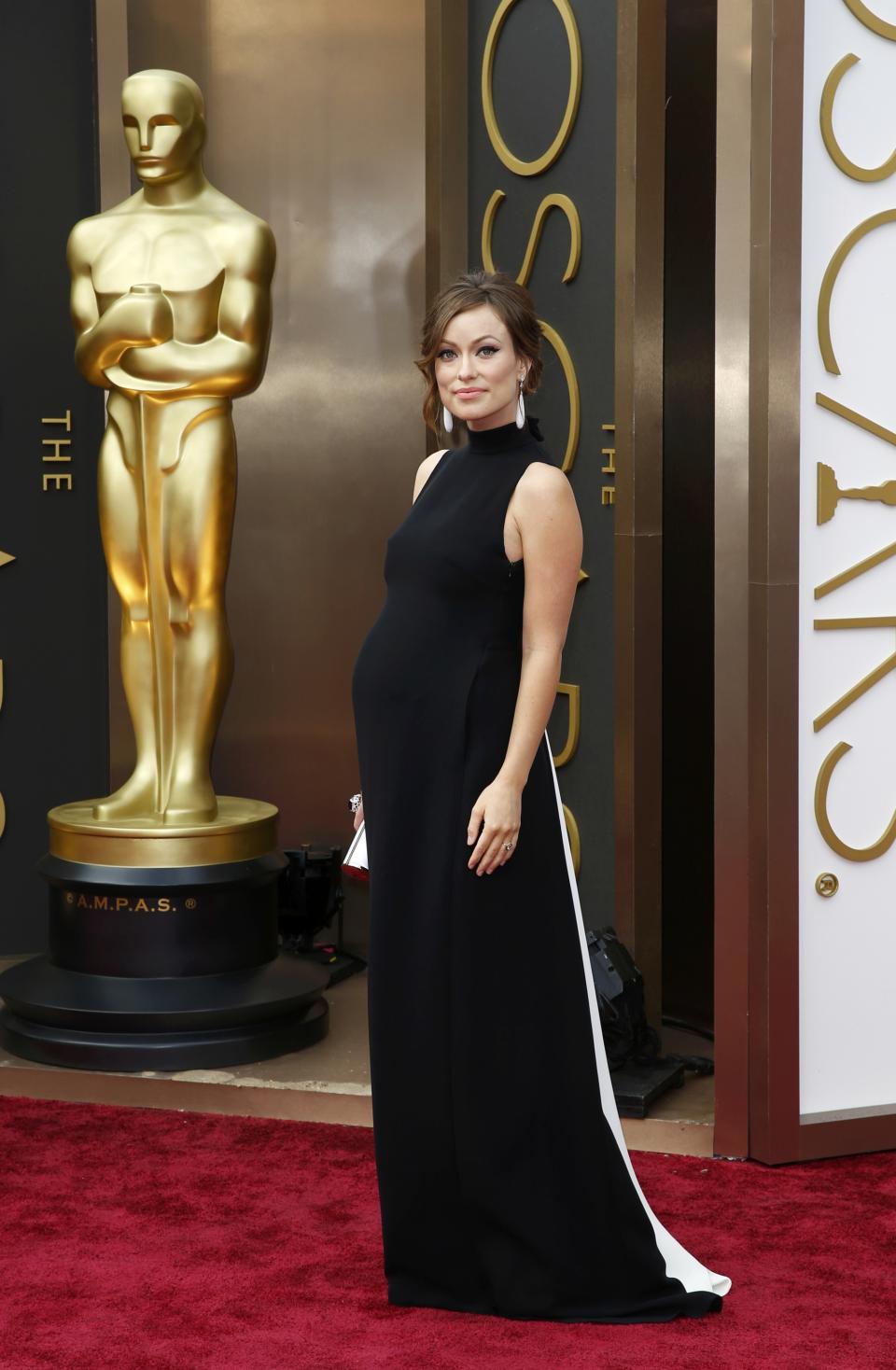 Actress Olivia Wilde wears a dress by Valentino as she arrives at the 86th Academy Awards in Hollywood, California March 2, 2014. REUTERS/Lucas Jackson (UNITED STATES - Tags: ENTERTAINMENT) (OSCARS-ARRIVALS)