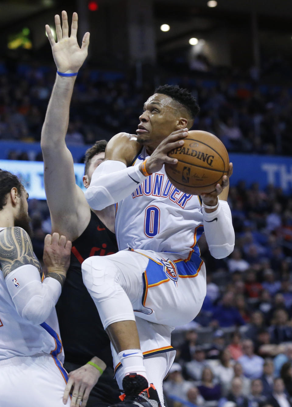 Oklahoma City Thunder guard Russell Westbrook, right, goes to the basket past Portland Trail Blazers center Jusuf Nurkic, center, in the first half of an NBA basketball game in Oklahoma City, Monday, Feb. 11, 2019. (AP Photo/Sue Ogrocki)
