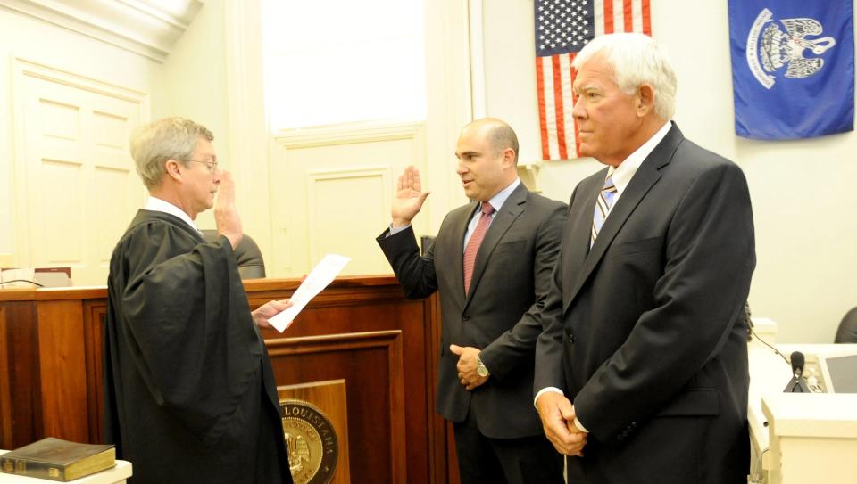 State District Judge John LeBlanc of Thibodaux, left, administers the oath of office to Assistant District Attorney Jason Chatagnier in 2016 as then-District Attorney Cam Morvant looks on.