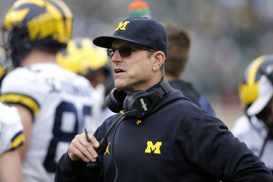 FILE -Michigan coach Jim Harbaugh watches during an NCAA college football game against Michigan State, Saturday, Oct. 30, 2021, in East Lansing, Mich. According to a person with knowledge of the process, New York Giants defensive coordinator Patrick Graham will interview at Vikings headquarters on Tuesday followed by Michigan head coach Jim Harbaugh on Wednesday, Feb. 2, 2022 . (AP Photo/Al Goldis, File)