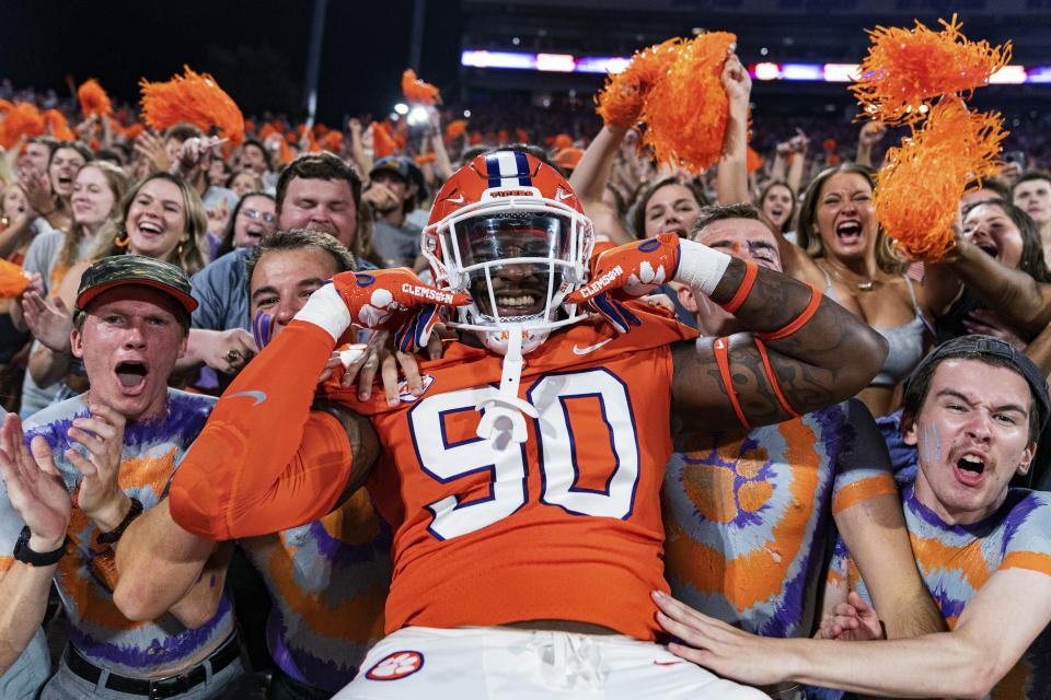 Clemson defensive tackle Jabriel Robinson poses with fans in the student section at the start of the team's NCAA college football game against Louisiana Tech on Saturday, Sept. 17, 2022, in Clemson, S.C. (AP Photo/Jacob Kupferman)