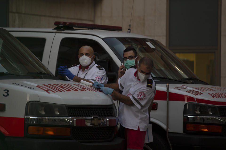 Paramedics stand by outside of the emergency department at Hadassah Medical Center in Jerusalem, where Senior Palestinian official Saeb Erekat is in critical condition with the coronavirus, Monday, Oct. 19, 2020. He was breathing with a ventilator after his infection worsened overnight, said the hospital. (AP Photo/Maya Alleruzzo)