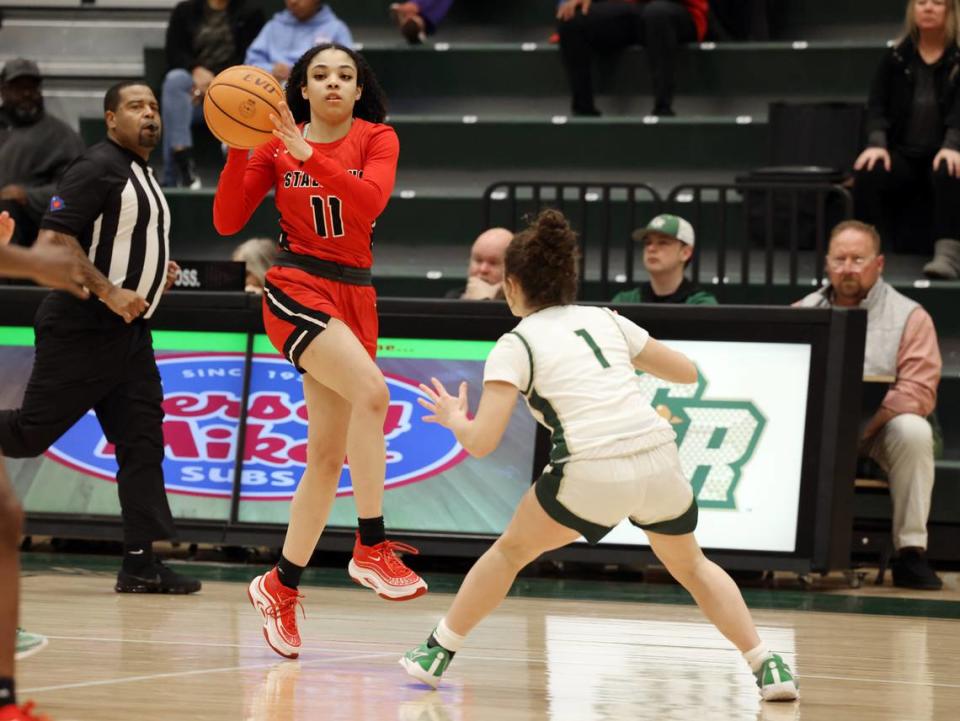 South Pointe’s Serenity Woods passes the ball over Catawba Ridge’s Cecila Gardner