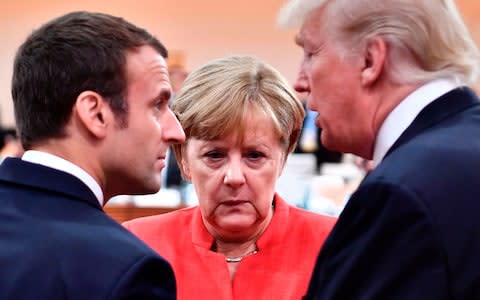 French President Emmanuel Macron, German Chancellor Angela Merkel and US President Donald Trump during the 2017 G20. - Credit: AFP