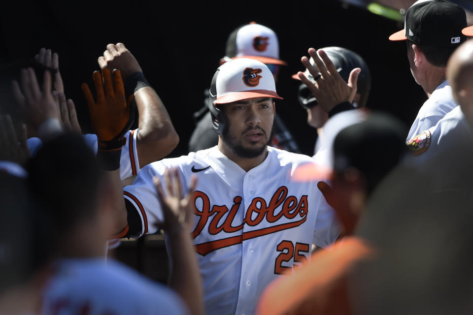 Baltimore Orioles' Anthony Santander is congratulated after hitting a two run home run against the Texas Rangers in the fourth inning of a baseball game Sunday, Sept. 26, 2021, in Baltimore. (AP Photo/Gail Burton)