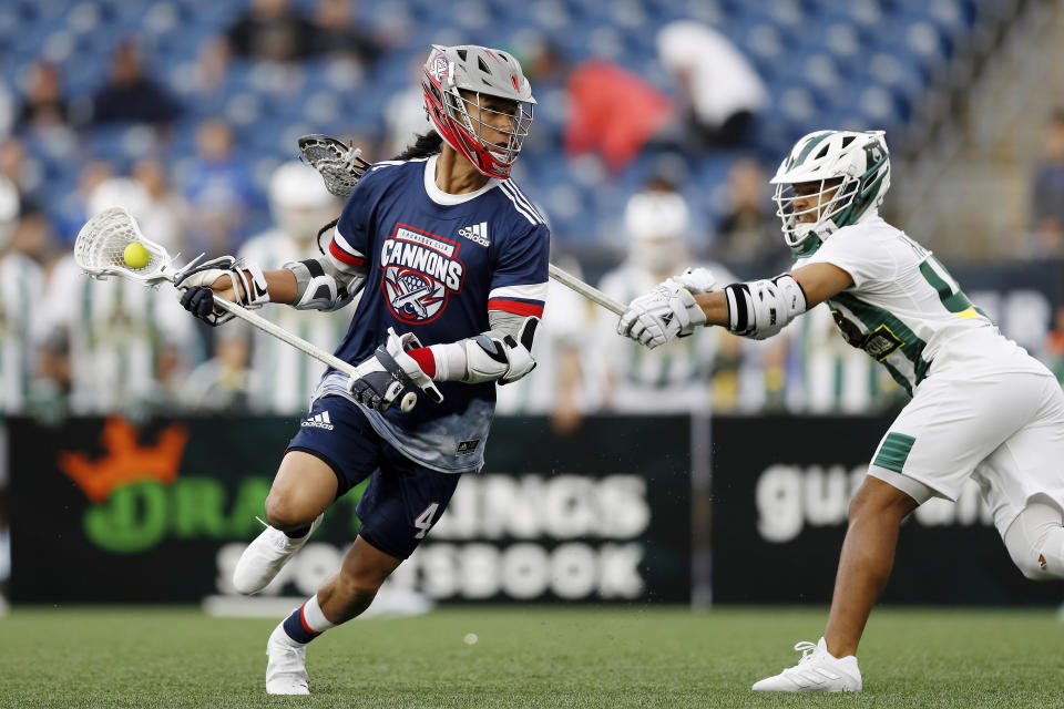 CFILE - Cannons' Lyle Thompson (4) carries the ball past Redwoods' Patrick Harbeson (40) during a Premier Lacrosse League game on Friday, June 4, 2021, in Foxborough, Mass. World Lacrosse, the international governing body of the sport, is making a proposal to have the Native American sport included in the 2028 Los Angeles Olympics. (AP Photo/Steve Luciano, File)