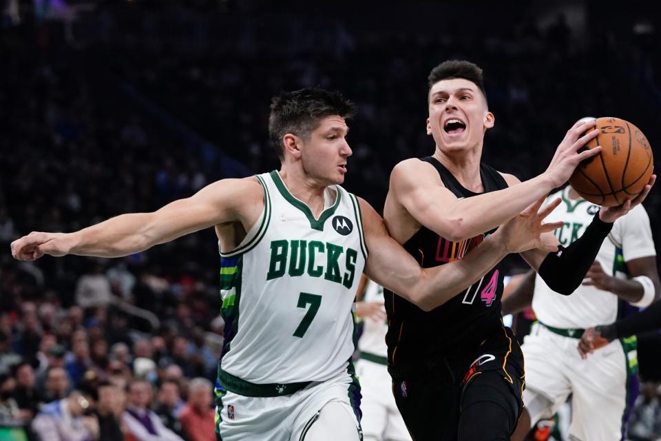 Miami Heat's Tyler Herro drives past Milwaukee Bucks' Grayson Allen during the first half of an NBA basketball game Wednesday, March 2, 2022, in Milwaukee . (AP Photo/Morry Gash)