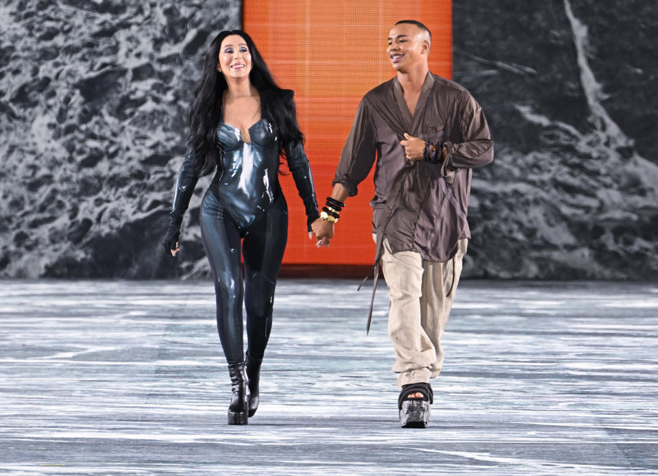 <p>Cher joins Balmain designer Olivier Rousteing on the runway at the Balmain fashion show during Paris Fashion Week on Sept. 28.</p>