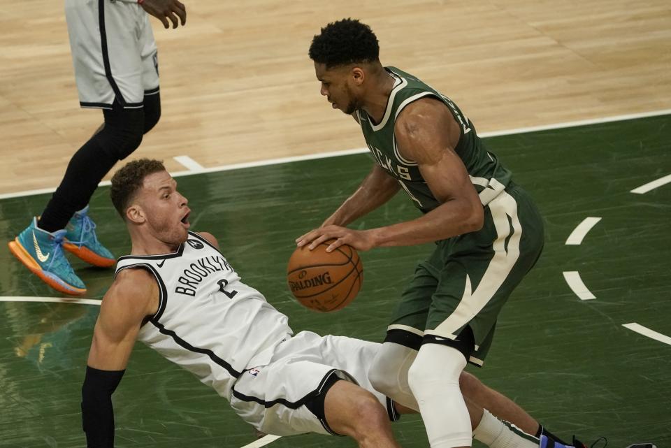 Brooklyn Nets' Blake Griffin draws a charge on Milwaukee Bucks' Giannis Antetokounmpo during the second half of an NBA basketball game Sunday, May 2, 2021, in Milwaukee. (AP Photo/Morry Gash)