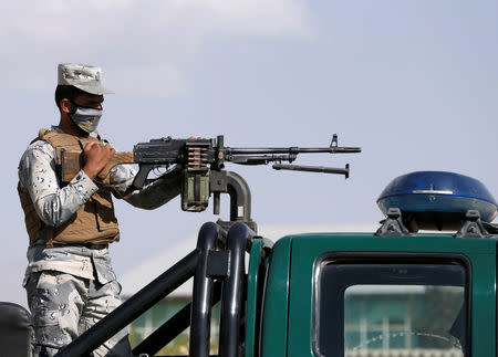 An Afghan police officer stands guard at a checkpoint, ahead of the parliamentary election, near a polling station in Kabul, Afghanistan October 19, 2018. REUTERS/Omar Sobhani