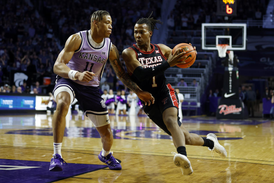 Texas Tech guard Lamar Washington (1) attempts to get past Kansas State forward Keyontae Johnson (11) as he attempts to score during the first half of an NCAA college basketball game on Saturday, Jan. 21, 2023, in Manhattan, Kan. (AP Photo/Colin E. Braley)