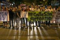 Demonstrators block a street with signs as they shout anti-government slogans to protest the detention of four students in Caracas, Venezuela, Saturday, Feb. 8, 2014. The detained students were arrested in Tachira state on Friday while protesting crime. The protests are part of a civil movement called "Street with no return" that is calling for street protests against the government of Venezuela's President Nicolas Maduro. (AP Photo/Alejandro Cegarra)