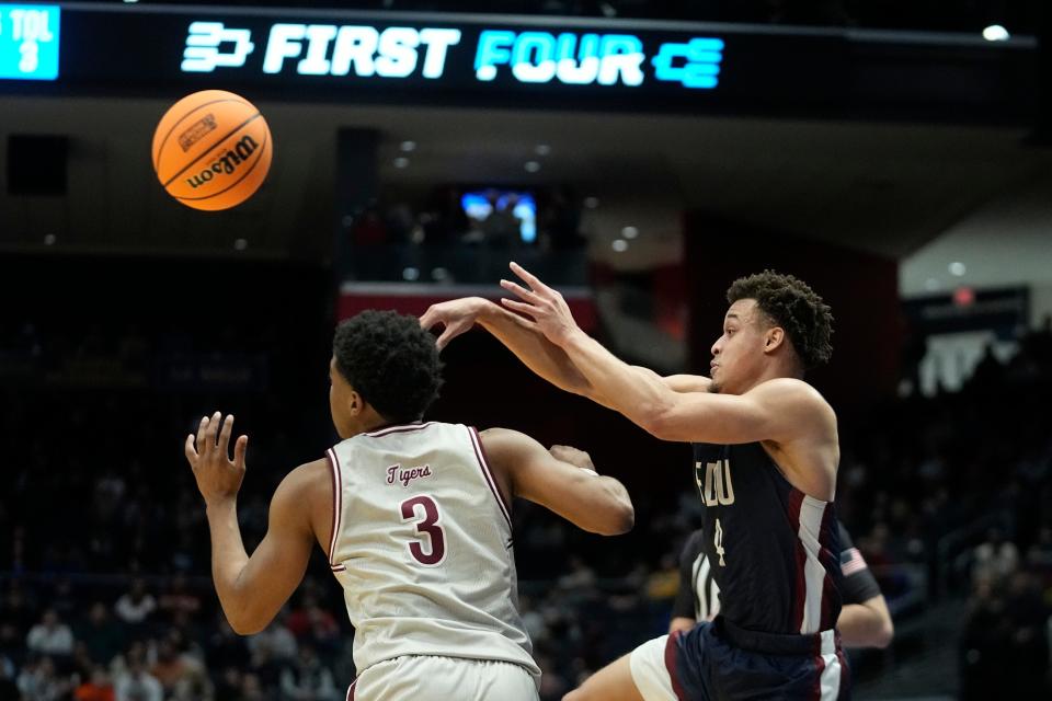 Fairleigh Dickinson's Grant Singleton (4) makes a pass against Texas Southern's PJ Henry (3) during the first half of a First Four college basketball game in the NCAA men's basketball tournament, Wednesday, March 15, 2023, in Dayton, Ohio. (AP Photo/Darron Cummings)