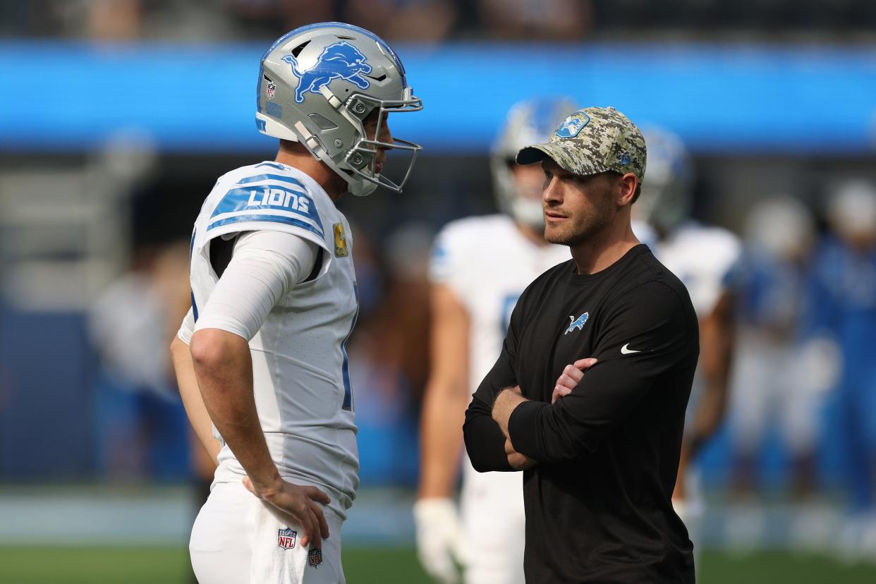 Lions quarterback Jared Goff talks with offensive coordinator Ben Johnson before the game against the Los Angeles Chargers on Sunday, Nov. 12, 2023, in Inglewood, California.