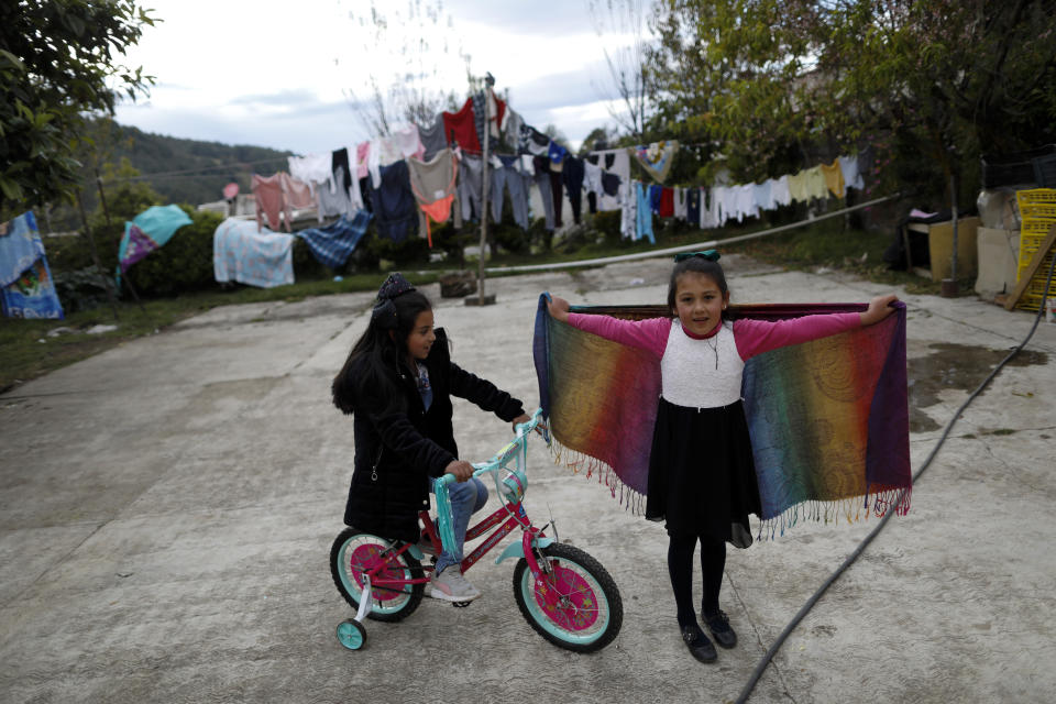 Nieces of environmental activist Homero Gomez Gonzalez play in a courtyard amid family homes during his wake in Ocampo, Michoacan state, Mexico, Thursday, Jan. 30, 2020. Relatives of the anti-logging activist who fought to protect the winter habitat of monarch butterflies don't know whether he was murdered or died accidentally, but they say they do know one thing for sure: something bad is happening to rights and environmental activists in Mexico, and people are afraid. (AP Photo/Rebecca Blackwell)