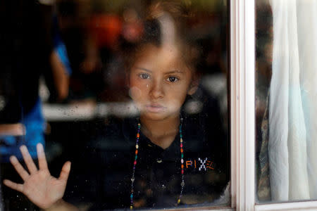 A Central American migrant, moving in a caravan through Mexico and traveling to request asylum in U.S, looks on as she makes a stop during her travels to Tijuana, at a shelter in San Luis Rio Colorado, in Sonora state, Mexico April 25, 2018. REUTERS/Edgard Garrido