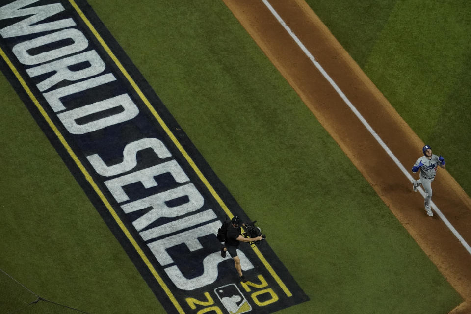 Los Angeles Dodgers first baseman Max Muncy celebrates a home run against the Tampa Bay Rays during the fifth inning in Game 5 of the baseball World Series Sunday, Oct. 25, 2020, in Arlington, Texas.(AP Photo/David J. Phillip)