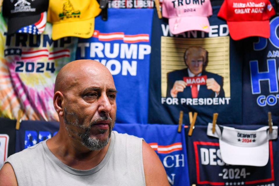 Joe Prince, 48, sells Trump merchandise from his mobile shop near the South Carolina State Fairgrounds after the 56th annual Silver Elephant Gala, where Trump was the keynote speaker, in Columbia, S.C., on Saturday, Aug. 5, 2023.