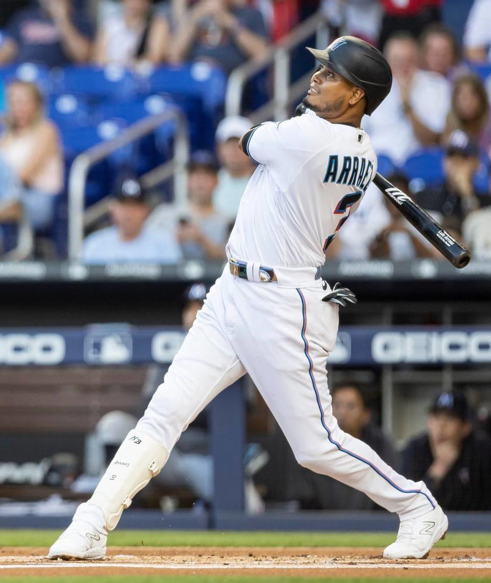 Miami Marlins second baseman Luis Arraez (3) hits a fly ball to center field against the Minnesota Twins during the first inning of an MLB game at loanDepot park on Tuesday, April 4, 2023, in Miami, Fla.