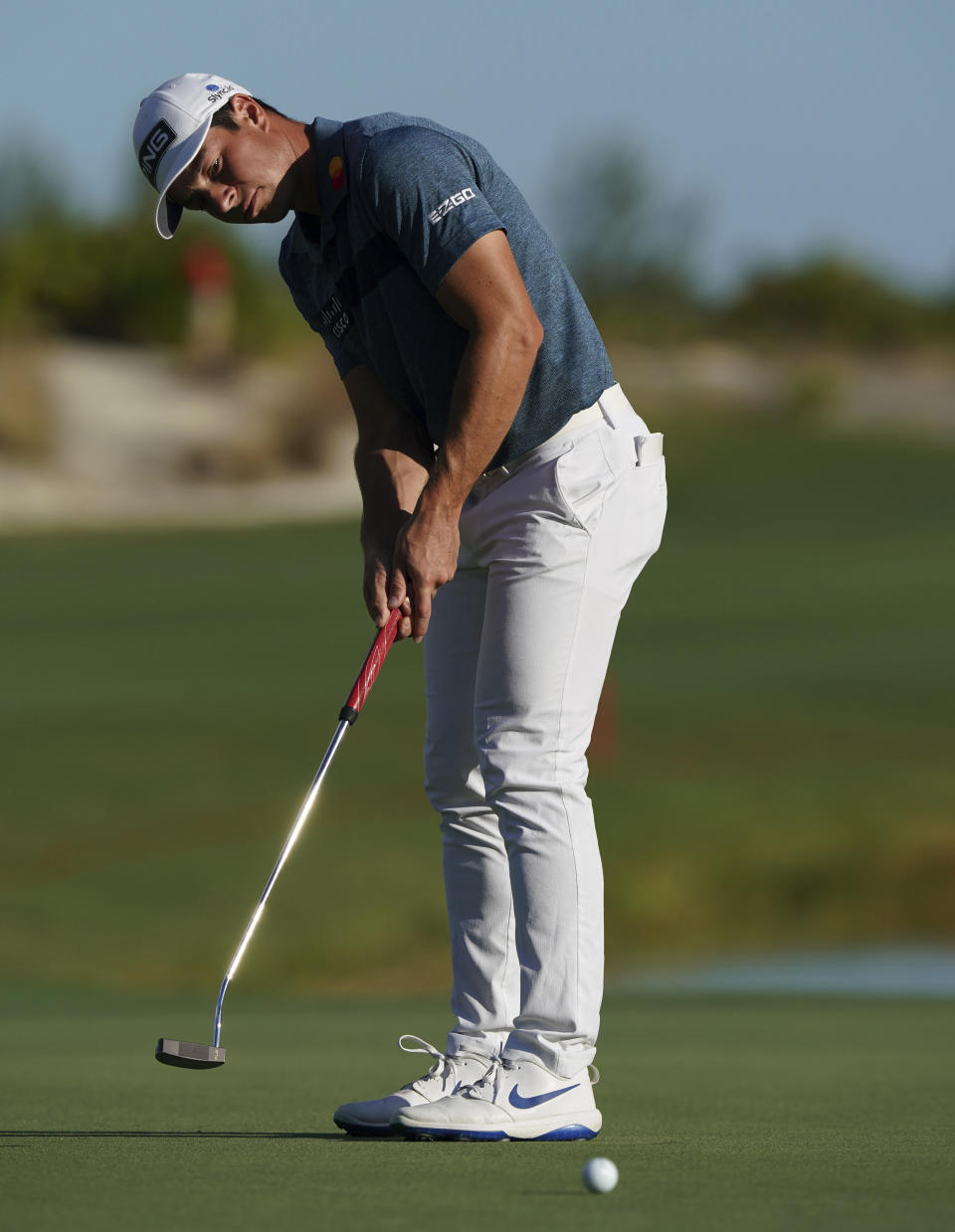 Viktor Hovland, of Norway, watches his putt on the 18th green during the second round of the Hero World Challenge PGA Tour at the Albany Golf Club, in New Providence, Bahamas, Friday, Dec. 3, 2021.(AP Photo/Fernando Llano)