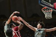 Oklahoma guard Grant Sherfield (25) shoots while being guarded by West Virginia forward Tre Mitchell (3) and West Virginia forward James Okonkwo (32) during the second half of an NCAA college basketball game in Morgantown, W.Va., Saturday, Feb. 4, 2023. (AP Photo/William Wotring)