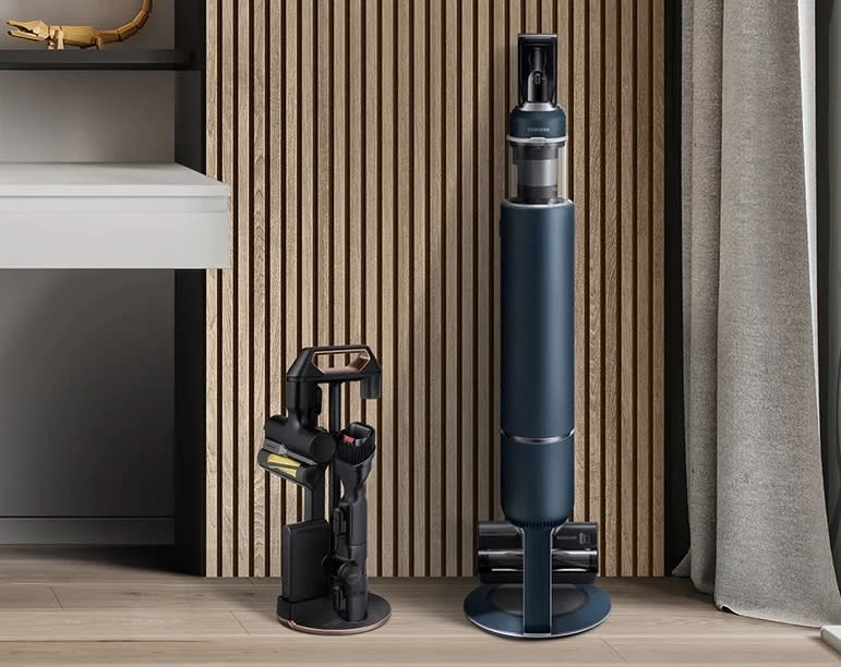 the samsung bespoke jet vacuum on the docking station in a living room