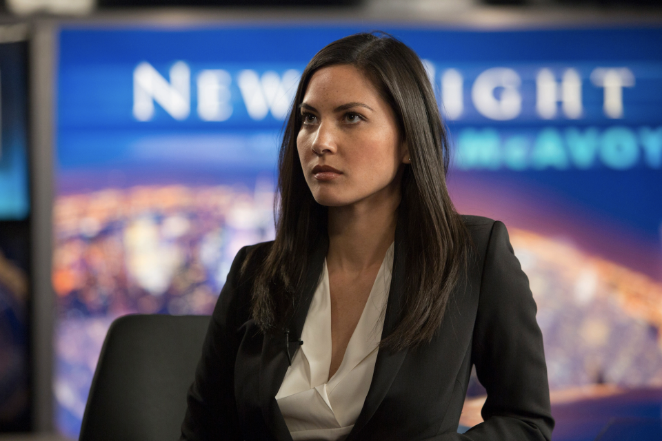 woman in a blazer inside a newsroom