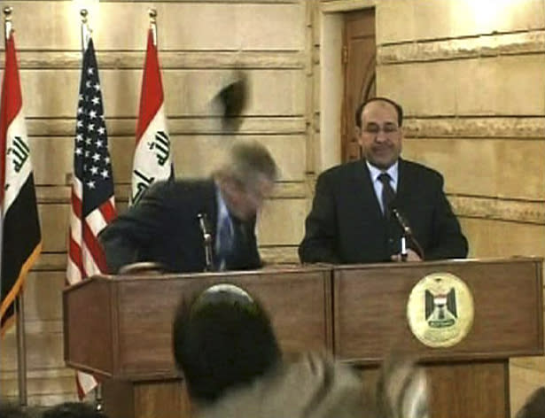 In this Sunday, Dec. 14, 2008 file image from APTN video, a man throws a shoe at President George W. Bush during a news conference with Iraq Prime Minister Nouri al-Maliki, in Baghdad. A court convicted an Iraqi journalist of assault Thursday, March 12, 2009 for hurling his shoes at George W. Bush and sentenced him to three years in prison, prompting an outburst from his family and calls for his release from Iraqis who consider him an icon for a nation decimated by war. (AP Photo/APTN)