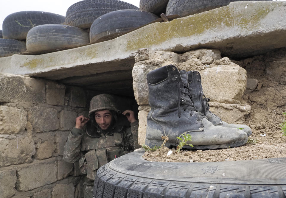 An Ethnic Armenian soldier stands at a fighting position on the front line, during a military conflict against Azerbaijan's armed forces in the separatist region of Nagorno-Karabakh, Wednesday, Oct. 21, 2020. Armenia's prime minister has urged citizens to sign up as military volunteers to help defend the country amid the conflict with Azerbaijan over the disputed territory of Nagorno-Karabakh as intense fighting has raged for a fourth week with no sign of abating. (AP Photo)