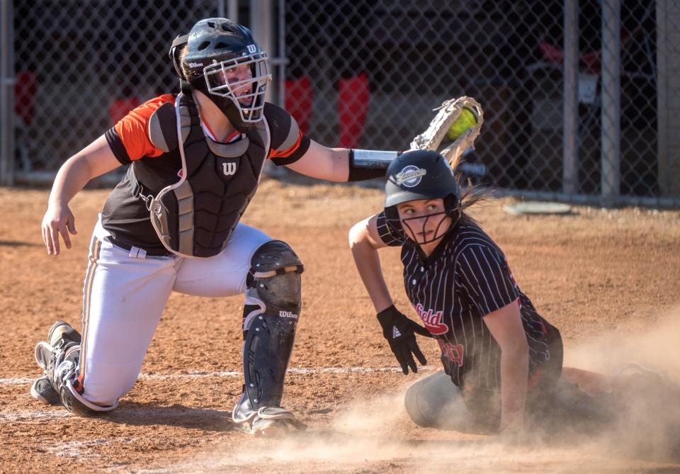 Illini Bluffs catcher Kristen Graham, left, and Brimfield baserunner Kierra Johnson look for the ump’s call after a play at the plate in the seventh inning Wednesday, May 5, 2021 at Brimfield High School. Johnson was out on the play and Illini Bluffs went on to win 8-3.