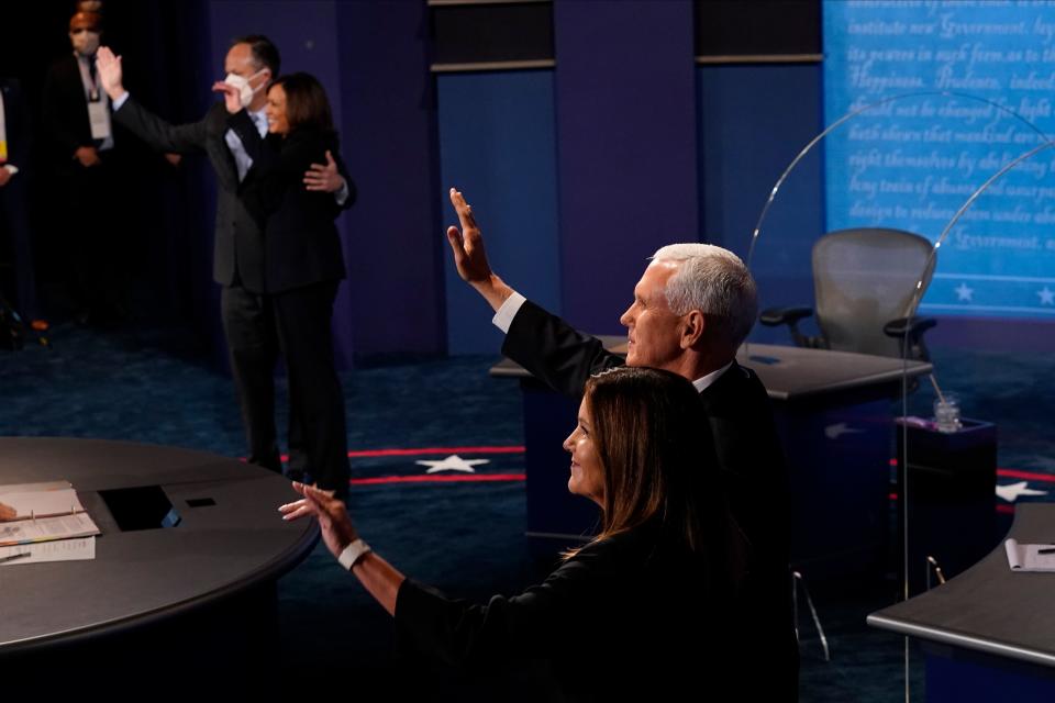 Vice President Mike Pence and his wife Karen Pence with Democratic vice presidential candidate Kamala Harris and her husband Douglas Emhoff wave at the end of the vice presidential debate on October 7, 2020, at Kingsbury Hall on the campus of the University of Utah in Salt Lake City. (Photo by Morry Gash / POOL / AFP) (Photo by MORRY GASH/POOL/AFP via Getty Images)
