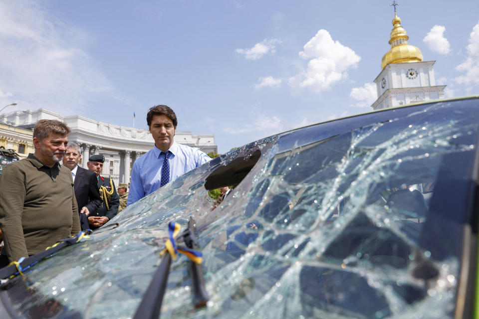 Canadian Prime Minister Justin Trudeau visits an exhibition of destroyed vehicles in Kyiv, Ukraine, Saturday June 10, 2023. (Valentyn Ogirenko/Pool via AP)