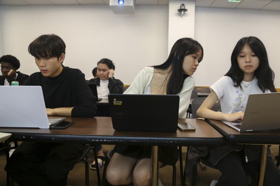 Students, from left, Zhuo Yan Jiang, 18 of Boston Latin School; Shuyi Zheng, 17 of Boston Latin Academy, and Wan Xin Chen, 17 of the John D. O'Bryant School of Mathematics & Science, work during a coding class in the Bridge to Calculus summer program at Northeastern University in Boston on Tuesday, Aug. 1, 2023. (AP Photo/Reba Saldanha)