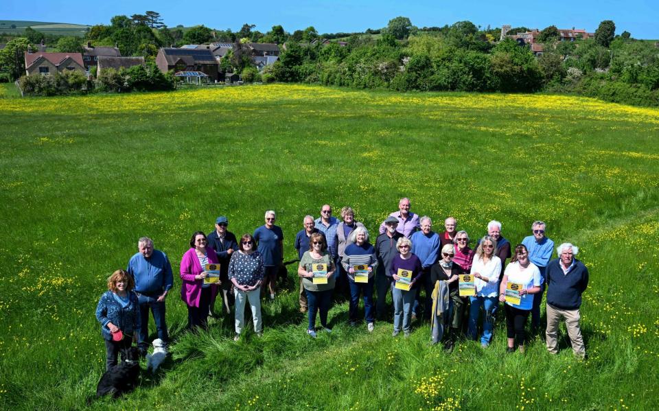 Villagers affected in a field with the 12thC church of St Michaelâ€™s - Paul Grover for the Telegraph