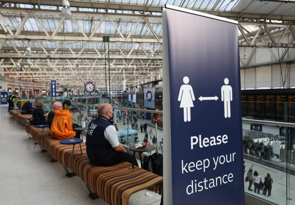 An information banner telling people to adhere to social distancing while sitting in London Waterloo train station as the bank holiday weekend approaches. Picture date: Friday August 28, 2020.