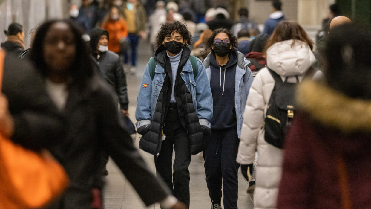 Commuters wearing masks at a subway station in New York City.