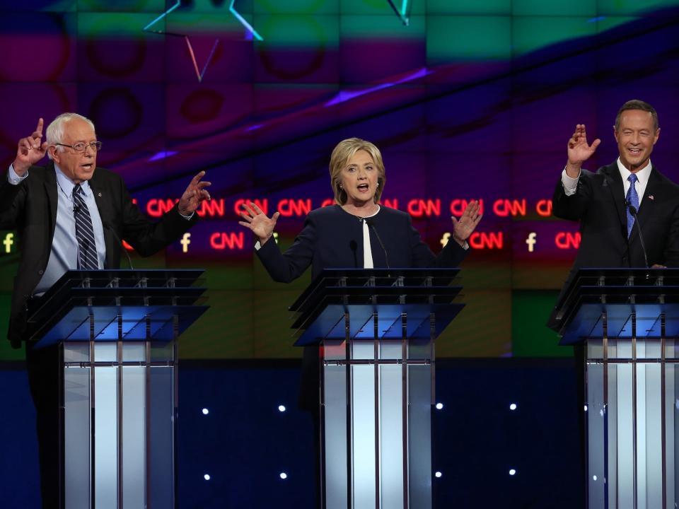 Bernie Sanders, Hillary Clinton, and Martin O'Malley gesture during a 2016 Democratic presidential primary debate.