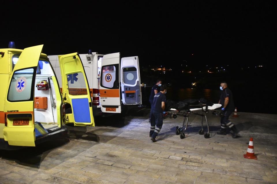 Paramedics wheel a gurney with a body at Pythagorio port, on the eastern Aegean island of Samos, Greece, late Monday, Sept. 13, 2021. Authorities in Greece Tuesday opened an investigation into the crash of a private plane from Israel that killed a prosecution witness in the corruption trial of former Israeli prime minister Benjamin Netanyahu. Haim Geron, a former senior official at Israel's ministry of communications, and his wife Esther were killed in the crash late Monday off the island of Samos. (AP Photo/Michael Svarnias)