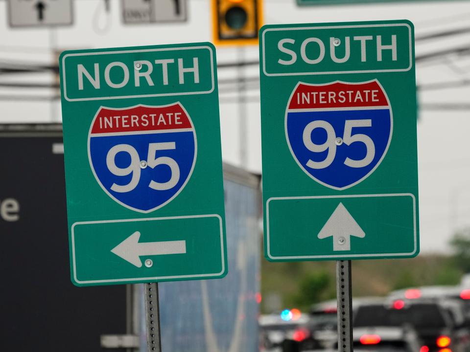 Interstate 95 signs stand near an elevated section that collapsed