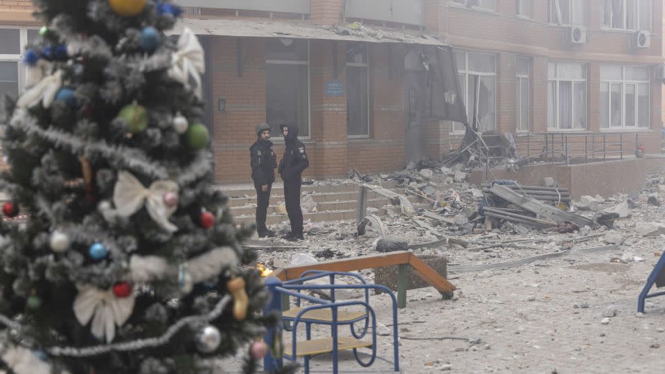 Police officers stand near a high-rise building hit by a rocket after a missile attack in Odesa, in southern Ukraine, on December 29. - Oleksandr Gimanov/AFP/Getty Images