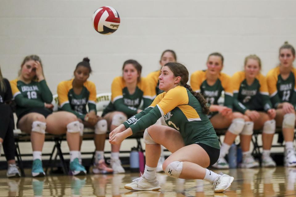 Ursuline's Maya Brausch (2) digs the ball against Notre Dame in the second set at Notre Dame Academy Oct. 11. The Lions face GGCL nemesis Mount Notre Dame in the regional semifinals.