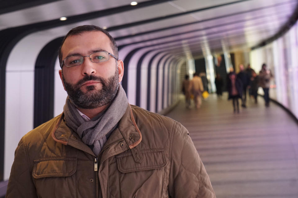 Mazen Masri, an academic and a consultant to the legal team suing the NSO Group in Israel over alleged abuses involving its spyware, poses for a photograph in a pedestrian underpass leading to King's Cross Station in London on Monday, Jan. 27, 2019. He is among half a dozen people who have been approached by undercover operatives on false pretexts over the past two months. All six have crossed paths with the NSO Group in some way. (AP Photo/Raphael Satter)